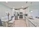 Modern kitchen featuring granite countertops and stainless steel appliances, open to dining at 3072 Inlet Breeze Way, Holiday, FL 34691