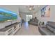 Open living space with modern decor, TV, and sliding doors leading to the outdoor area, blending indoor/outdoor living at 3072 Inlet Breeze Way, Holiday, FL 34691