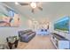Bright living area featuring a modern ceiling fan, stylish decor, and neutral-toned flooring throughout at 3072 Inlet Breeze Way, Holiday, FL 34691
