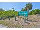 Anclote Gulf Park sign surrounded by trees, showing park amenities like picnic and kayak launch at 3072 Inlet Breeze Way, Holiday, FL 34691