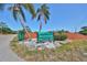 Anclote River Park sign, surrounded by palm trees, rocks, and greenery under a clear blue sky at 3072 Inlet Breeze Way, Holiday, FL 34691