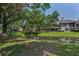 Well-maintained backyard with a pond, lush green lawn, and mature trees offering shade at 3079 Landmark Blvd # 1608, Palm Harbor, FL 34684