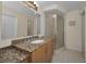 Bright bathroom with granite countertops, updated sink and glass-enclosed shower at 3079 Landmark Blvd # 1608, Palm Harbor, FL 34684