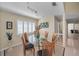 Bright dining room with glass table, shuttered windows, and stylish lighting at 3079 Landmark Blvd # 1608, Palm Harbor, FL 34684