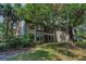Exterior view of the building showcasing well-kept landscaping, lush trees, and architectural details at 3079 Landmark Blvd # 1608, Palm Harbor, FL 34684
