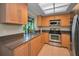 Well-lit kitchen with stainless steel appliances, granite countertops, and ample cabinet space at 3079 Landmark Blvd # 1608, Palm Harbor, FL 34684