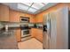 Efficient kitchen layout with stainless steel appliances, granite countertops, and bright lighting at 3079 Landmark Blvd # 1608, Palm Harbor, FL 34684