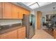 Well-lit kitchen featuring stainless steel refrigerator and granite countertops at 3079 Landmark Blvd # 1608, Palm Harbor, FL 34684