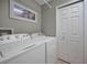 Neat laundry room with white washer and dryer, and a double door closet at 3079 Landmark Blvd # 1608, Palm Harbor, FL 34684