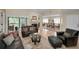 Open-concept living room flowing into dining area with fireplace and hardwood floors at 3079 Landmark Blvd # 1608, Palm Harbor, FL 34684