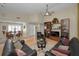 Open living room with hardwood floors, modern lighting, and dining area view at 3079 Landmark Blvd # 1608, Palm Harbor, FL 34684