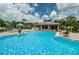 Inviting community pool with comfortable lounge chairs and a covered pavilion for relaxation at 3079 Landmark Blvd # 1608, Palm Harbor, FL 34684