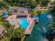 Aerial shot of a stunning community pool and spa area, complete with lounge chairs and shaded gazebo at 3079 Landmark Blvd # 1608, Palm Harbor, FL 34684