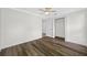 Bedroom features neutral walls, ceiling fan and stylish dark wood flooring at 3123 Laird Dr, New Port Richey, FL 34655