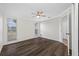 Bright bedroom featuring neutral walls, a ceiling fan, and stylish dark wood flooring at 3123 Laird Dr, New Port Richey, FL 34655