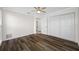 Bedroom featuring modern ceiling fan, two windows, and a closet with bi-fold doors at 3123 Laird Dr, New Port Richey, FL 34655