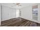 Bedroom showcasing multiple windows, ceiling fan and closet doors with plenty of natural light at 3123 Laird Dr, New Port Richey, FL 34655