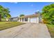Home's front exterior has an attached garage, small front yard, and concrete driveway at 3123 Laird Dr, New Port Richey, FL 34655