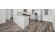 Well-lit kitchen features stainless steel appliances, gray-veined countertops, and wood flooring at 3123 Laird Dr, New Port Richey, FL 34655