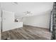 Spacious living room features gray-toned wood floors, modern ceiling fan, and freshly painted walls at 3123 Laird Dr, New Port Richey, FL 34655