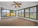 Enclosed sunroom features large windows for natural light and views of the backyard at 3123 Laird Dr, New Port Richey, FL 34655