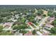 An aerial view showcases the home's location in a serene, tree-lined neighborhood at 3268 Tanglewood Trl, Palm Harbor, FL 34685