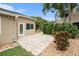 Backyard patio with a brick patio with landscaping and a lovely garden at 3268 Tanglewood Trl, Palm Harbor, FL 34685