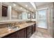 Elegant bathroom with double vanity, granite countertop, and decorative framed mirror at 3268 Tanglewood Trl, Palm Harbor, FL 34685