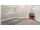 Spacious bedroom featuring plush gray carpeting and an open doorway to the rest of the home at 3268 Tanglewood Trl, Palm Harbor, FL 34685