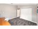 Well lit bedroom featuring modern carpeting and a large closet at 3268 Tanglewood Trl, Palm Harbor, FL 34685