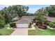 Charming home with mature landscaping and a two-car garage, creating excellent curb appeal at 3268 Tanglewood Trl, Palm Harbor, FL 34685