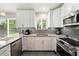 Bright, modern kitchen featuring granite countertops and stainless steel appliances at 3268 Tanglewood Trl, Palm Harbor, FL 34685