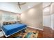 Bedroom features hardwood floors, ceiling fan, and a large window at 3268 Tanglewood Trl, Palm Harbor, FL 34685