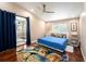 Bright main bedroom featuring hardwood floors, ceiling fan, and sliding doors to the lanai at 3268 Tanglewood Trl, Palm Harbor, FL 34685