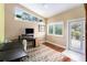 Bright home office space featuring a large window and a glass paneled door at 3268 Tanglewood Trl, Palm Harbor, FL 34685