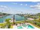 Beautiful aerial view of backyard pool and the serene canal, offering a private waterfront oasis with lush landscaping at 344 Capri Blvd, Treasure Island, FL 33706