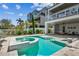 Modern backyard with pool, spa, and an outdoor kitchen and seating area, perfect for entertaining guests at 344 Capri Blvd, Treasure Island, FL 33706