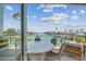 Waterfront view from the patio overlooking the ocean with comfortable lounge seating at 344 Capri Blvd, Treasure Island, FL 33706