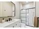 Bathroom featuring floating vanity, walk-in shower with a glass enclosure, and neutral color palette at 344 Capri Blvd, Treasure Island, FL 33706