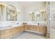 A well-lit bathroom features dual vanities with marble countertops, modern fixtures, and tile flooring, offering luxury and style at 344 Capri Blvd, Treasure Island, FL 33706