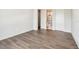 Empty bedroom with hardwood floors, neutral walls, and ensuite bathroom and closet doors at 344 Capri Blvd, Treasure Island, FL 33706