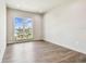 A naturally lit empty bedroom with wood floors and a large window overlooking the water at 344 Capri Blvd, Treasure Island, FL 33706