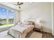 Serene bedroom with a large window, neutral tones, and minimalist decor at 344 Capri Blvd, Treasure Island, FL 33706