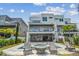 Stunning backyard featuring a pool, spa, fire pit, patio, and a spiral staircase leading to an upper balcony at 344 Capri Blvd, Treasure Island, FL 33706