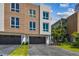 Striking multi-story home featuring a stylish mix of wood and white siding with a private two car garage at 344 Capri Blvd, Treasure Island, FL 33706