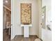 Hallway with a decorative wall piece that leads to a walk-in closet, bathroom, and laundry room, offering functionality at 344 Capri Blvd, Treasure Island, FL 33706