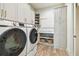 The spacious laundry room has modern appliances, ample cabinet storage, and a functional countertop at 344 Capri Blvd, Treasure Island, FL 33706