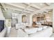Stylish living room with a fireplace, white sofas, and views leading into an open-concept kitchen at 344 Capri Blvd, Treasure Island, FL 33706
