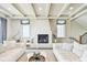 Elegant living room featuring a cozy fireplace, white sofas, and a soothing, neutral color palette at 344 Capri Blvd, Treasure Island, FL 33706