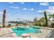 Sparkling swimming pool with built-in spa and lounge chair on the tanning ledge with beautiful waterfront views at 344 Capri Blvd, Treasure Island, FL 33706